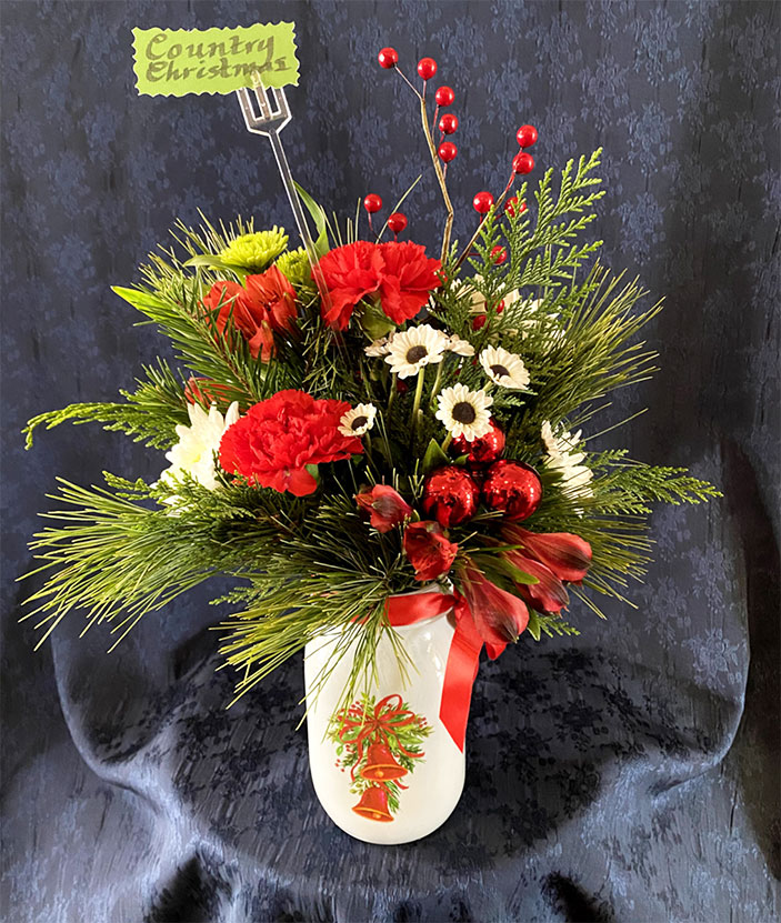 Country Christmas $35 Decorative white mason jar, seasonal greens of fir and cedar, red carnations, green and white pom-poms, red alstroemeria, red berries and seasonal ribbon.